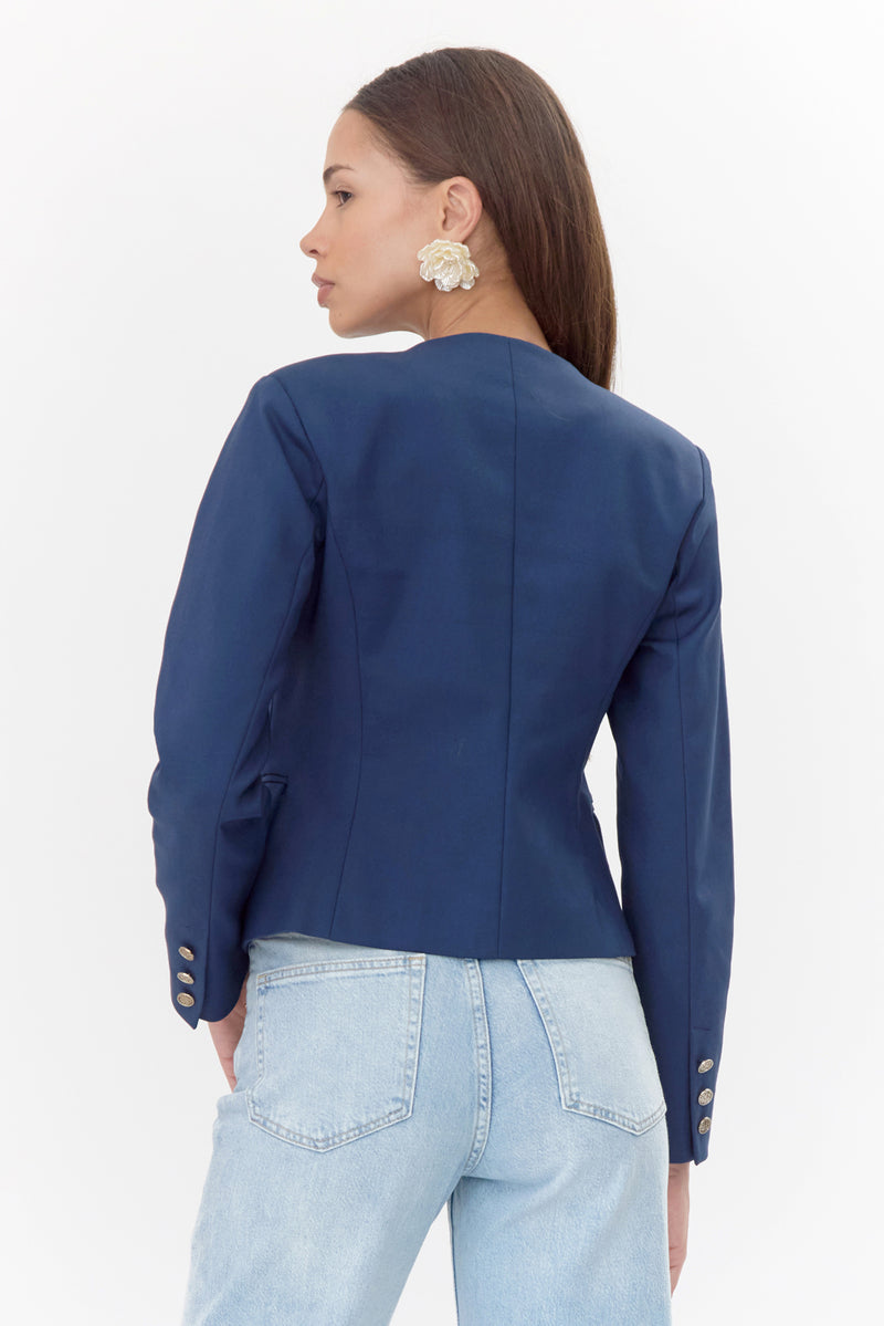 Back view of model wearing navy jacket.