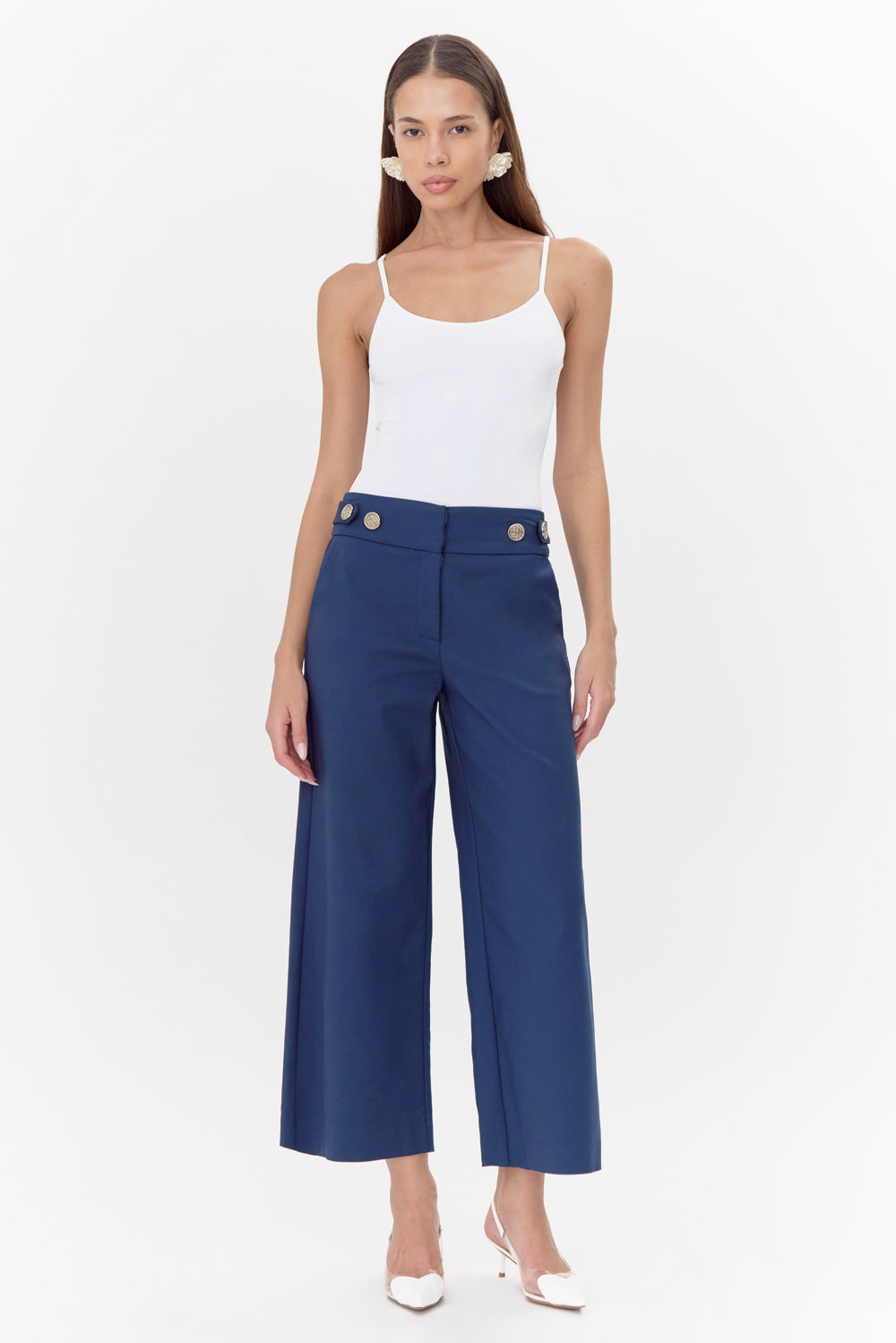 Model wears navy, wide-leg trousers with white, cami top.